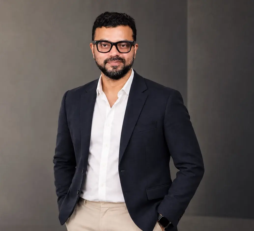 M Asif Rahman in a navy blazer and white shirt