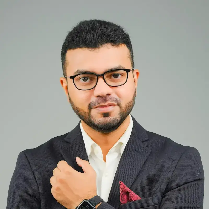 M Asif Rahman wearing glasses and a charcoal blazer